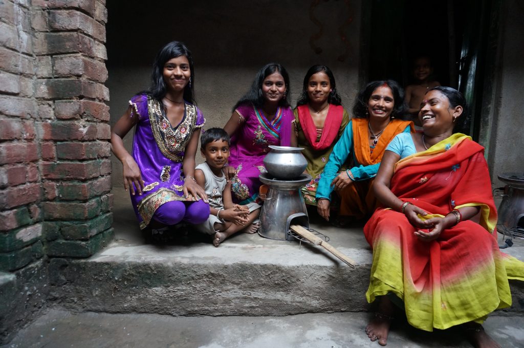 A family in India gathers around a BioLite Home Stove (credit: BioLite)