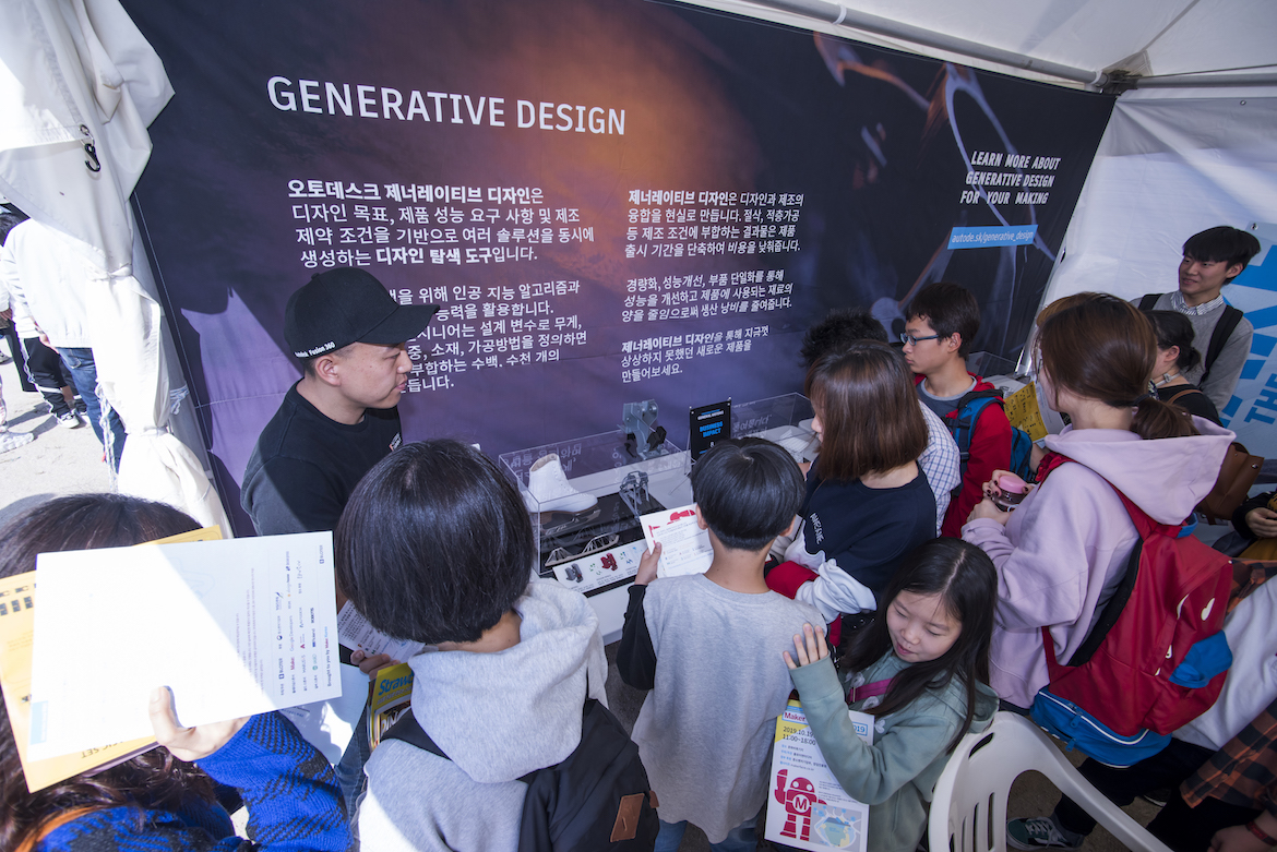 Korean visitors examine a technology display at Maker Faire in Seoul, Korea.