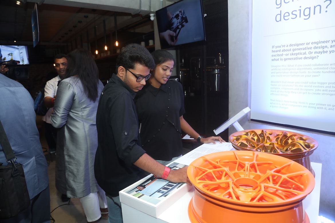 Guests looking at a display of the redesigned wheel rims of Volkswagen’s VW bus