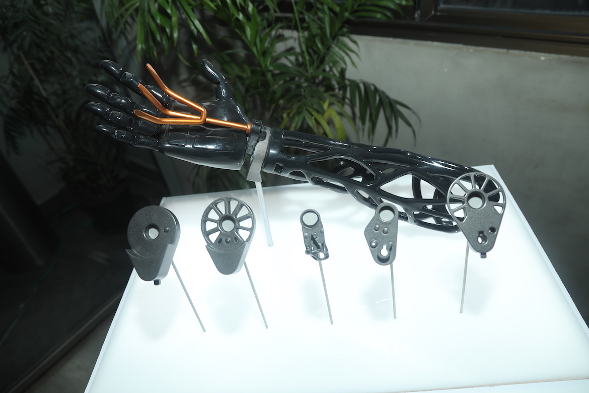 display of a prosthetic arm with different parts that were created with generative design. 