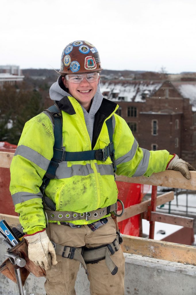 Female construction worker in a properly fitting safety harness.