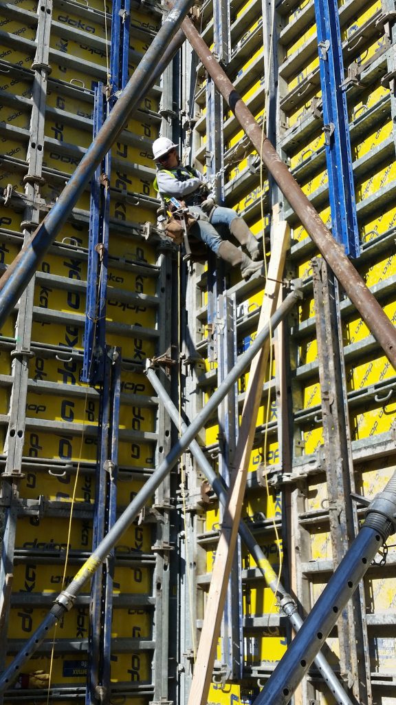 Woman working at height on a construction project.