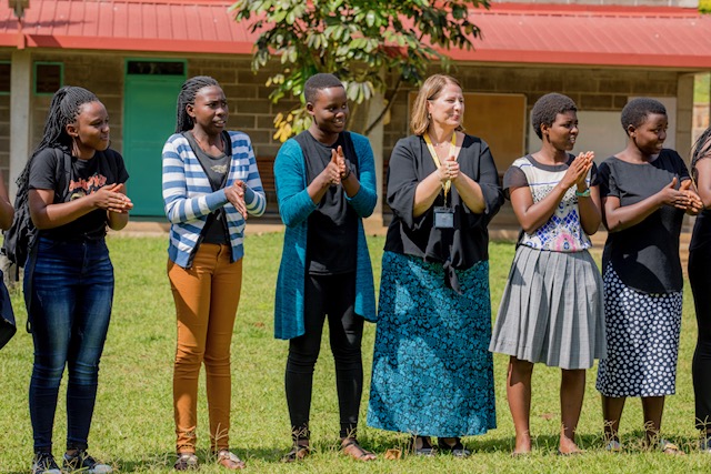 a group of women in a row outside