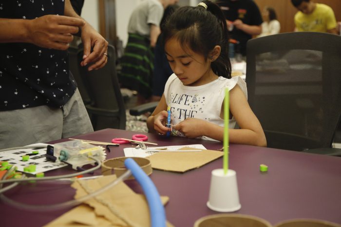 Child working at table at Spark!Lab