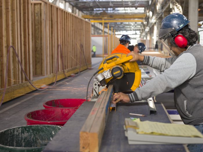 workers cutting wood in a factory