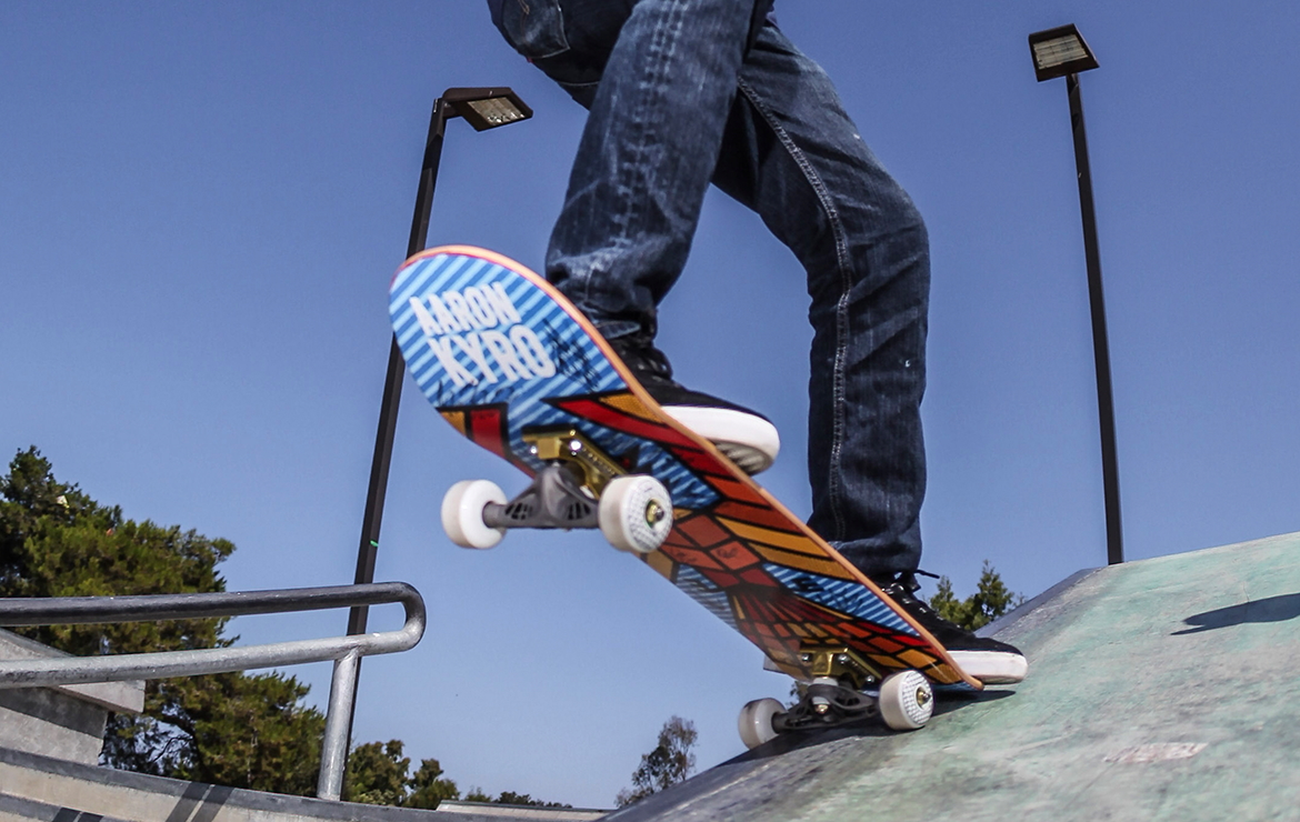 Underside of skateboard showing a 3D-printed, generatively designed skateboard truck 