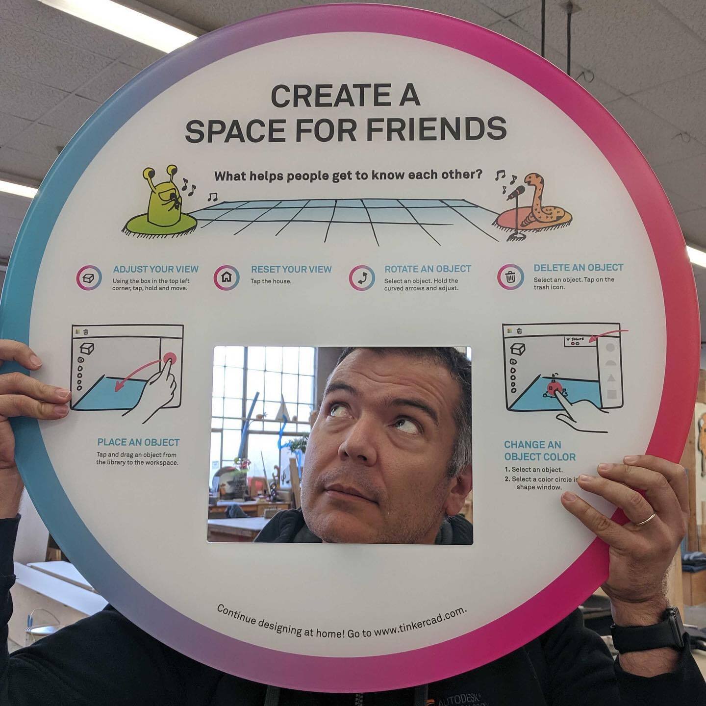 man posing with sign that creates "Create a space for friends"