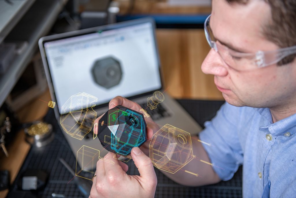 designer looking at a schematic overlay of a product prototype