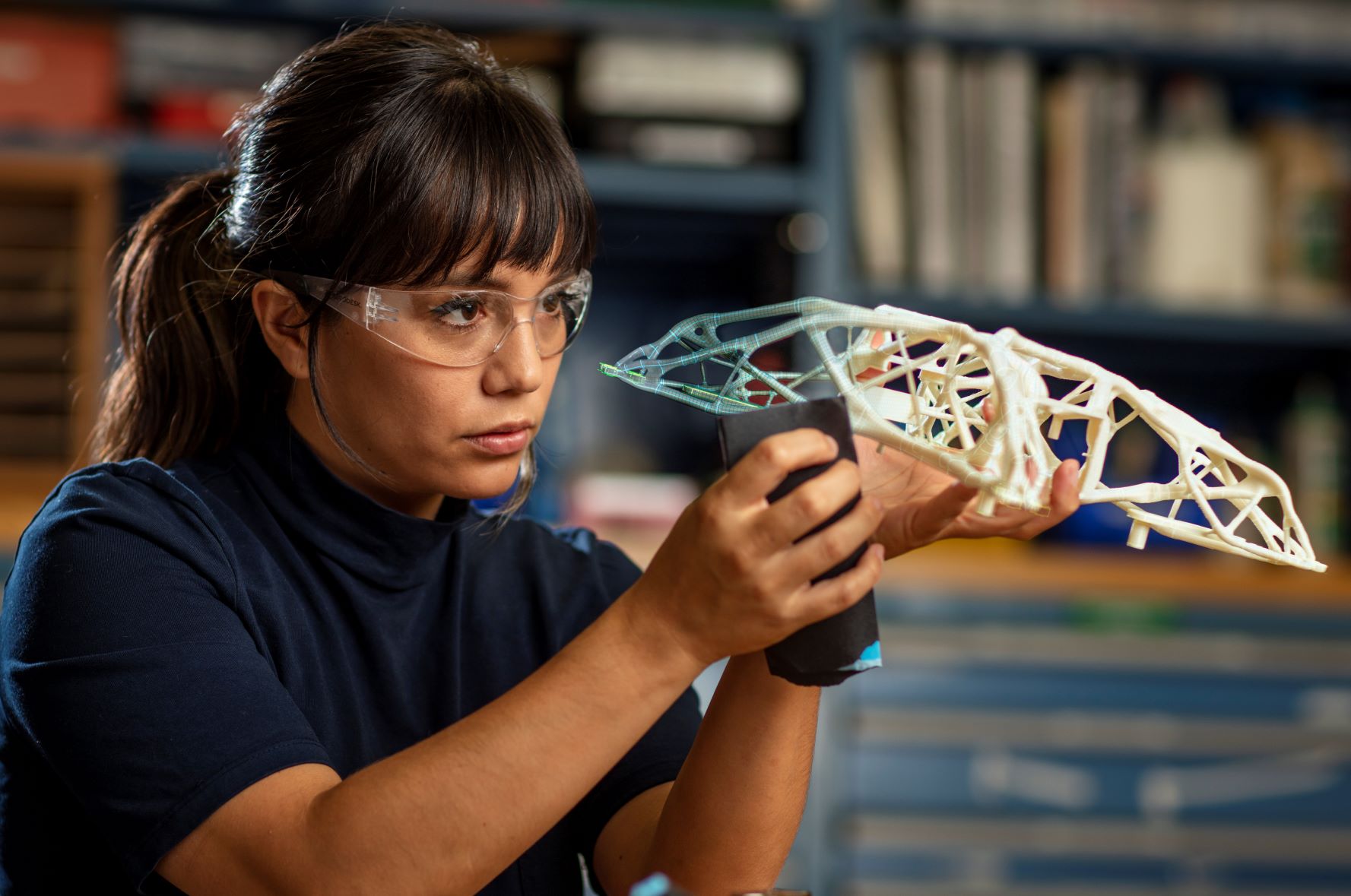 Woman working with a generatively designed part at the Autodesk San Francisco Technology Center.