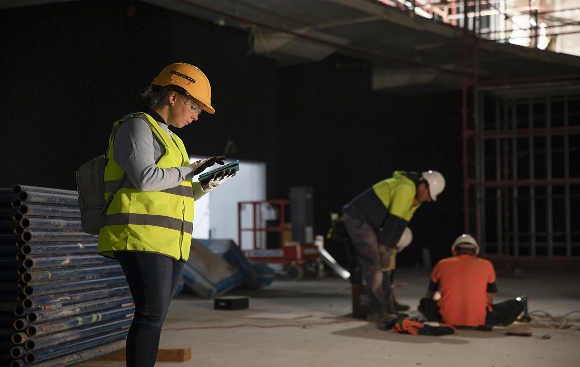 construction worker using mobile device on a project.