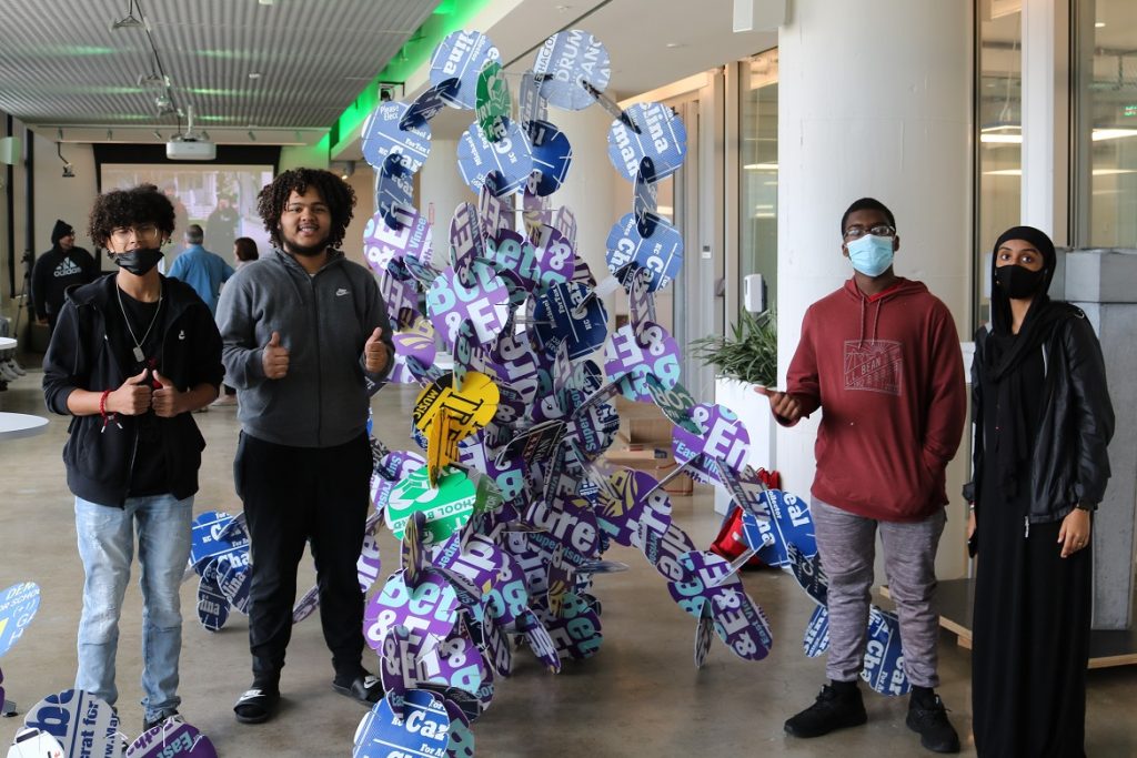 Students admire sculpture they created