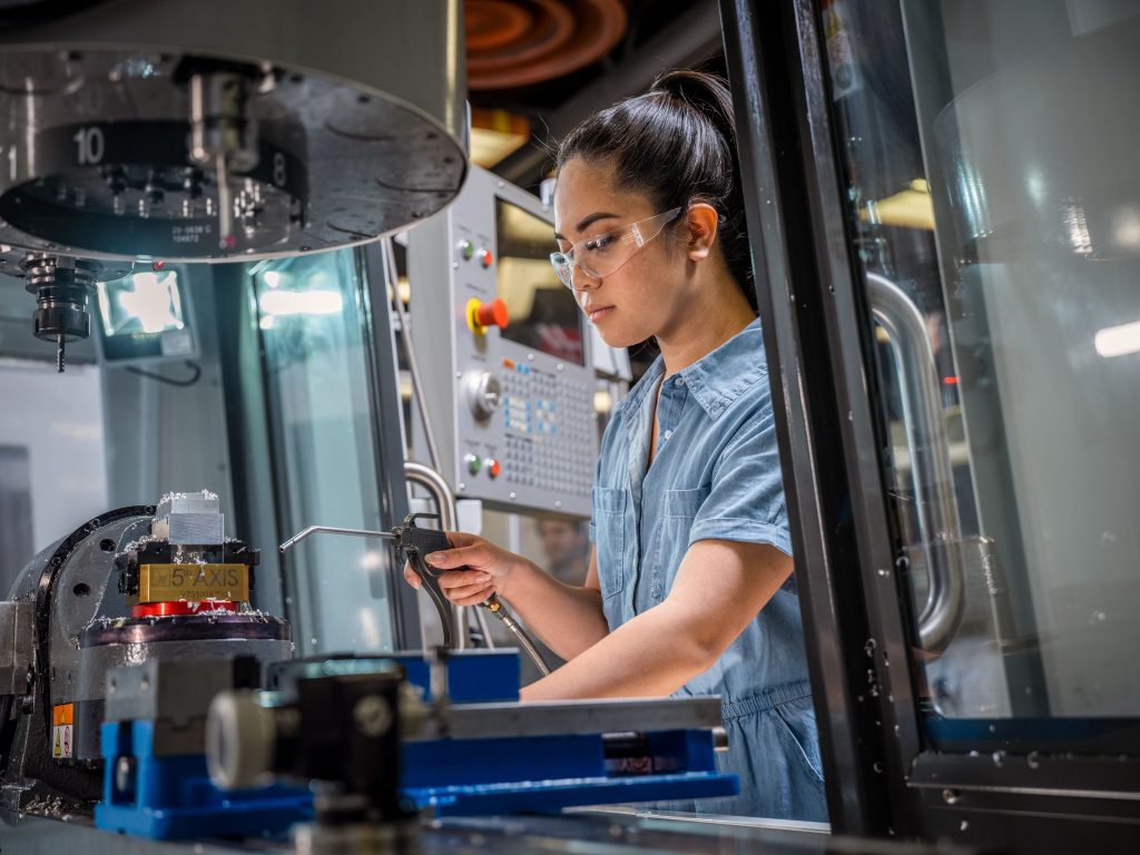 Employee operates 5-axis machine