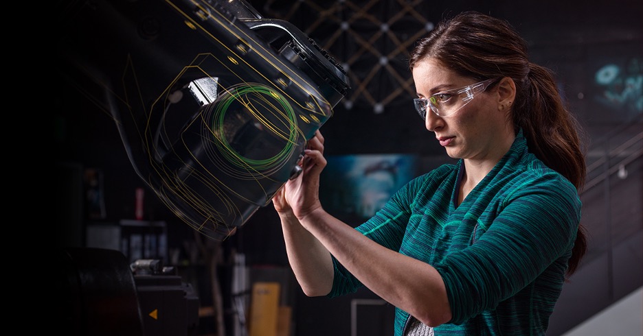 A person works on a machining tool. 