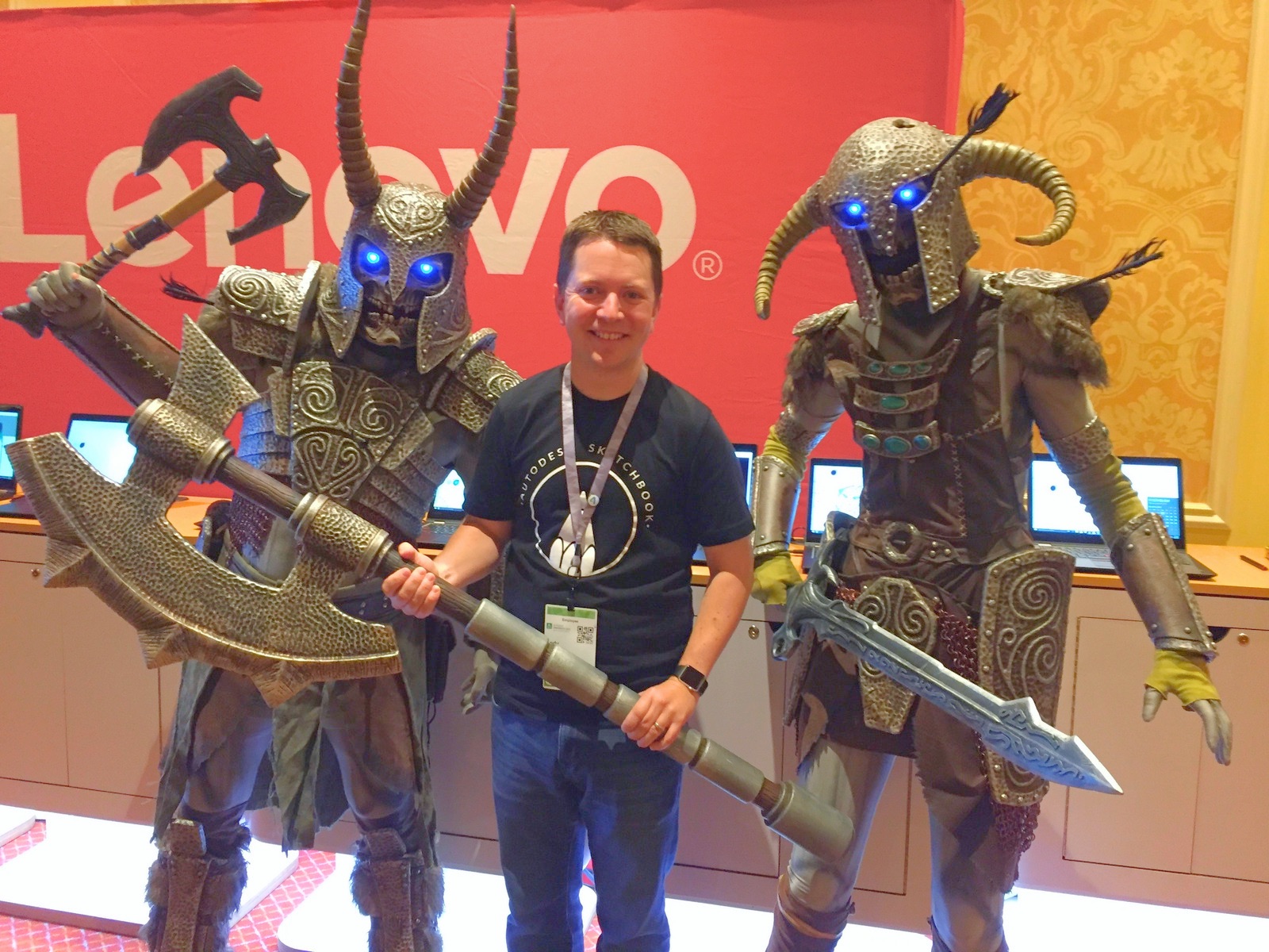 Man posing with monsters at tech conference