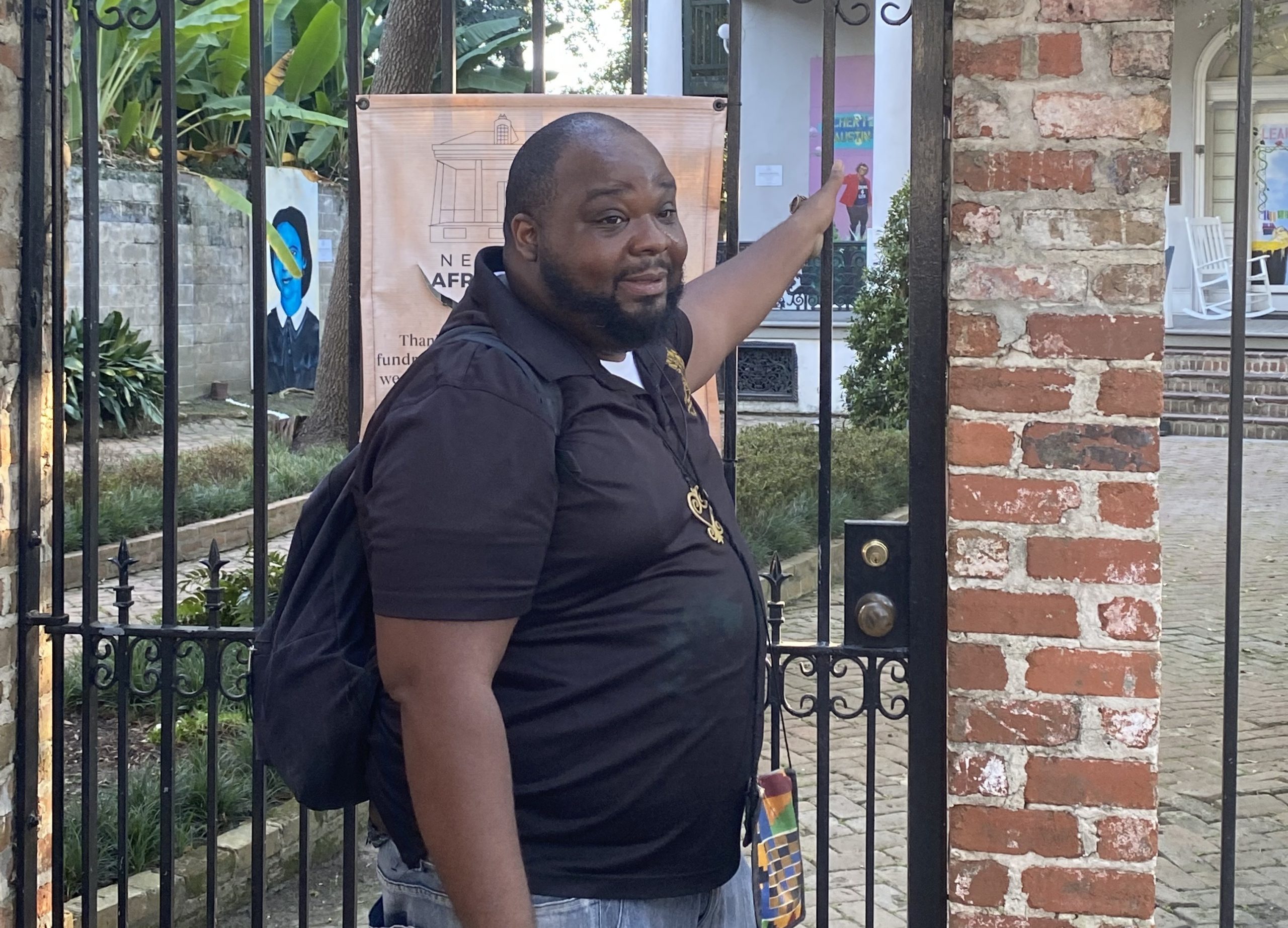 Walking tour guide in front of iron gate