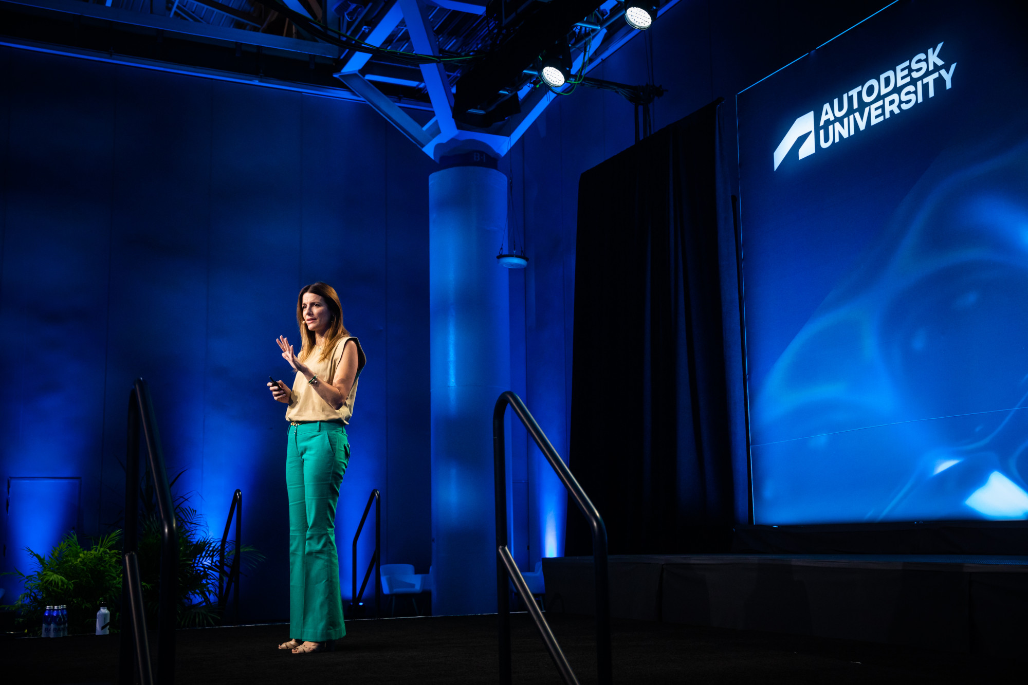 Executive speaking on stage at Autodesk University conference