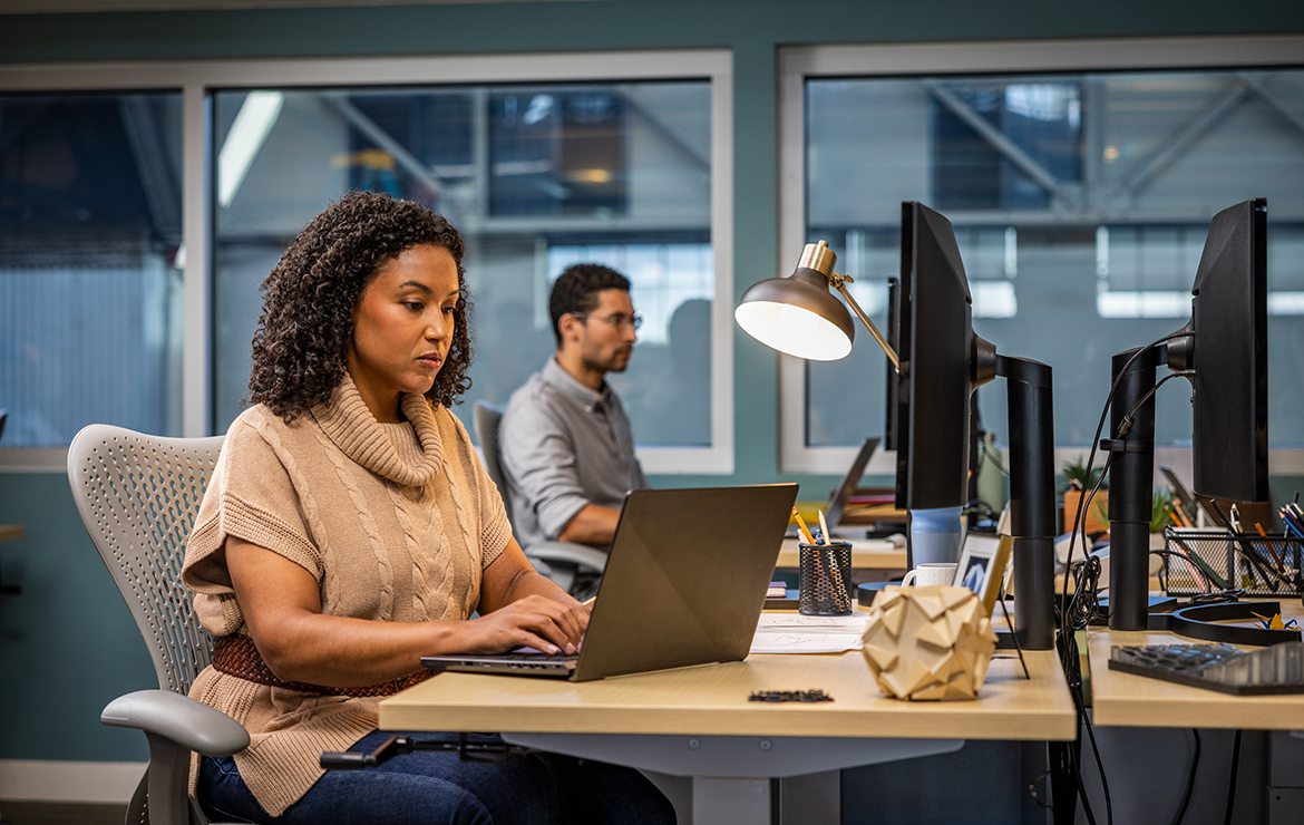 Woman and men working at a computer