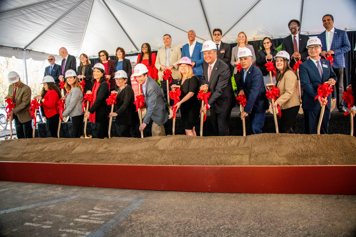 Group of people with shovels at a groundbreaking event