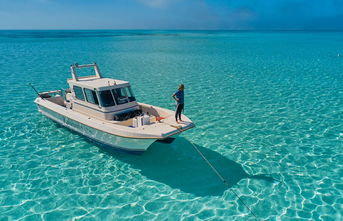 boat in the middle of very clear blue waters