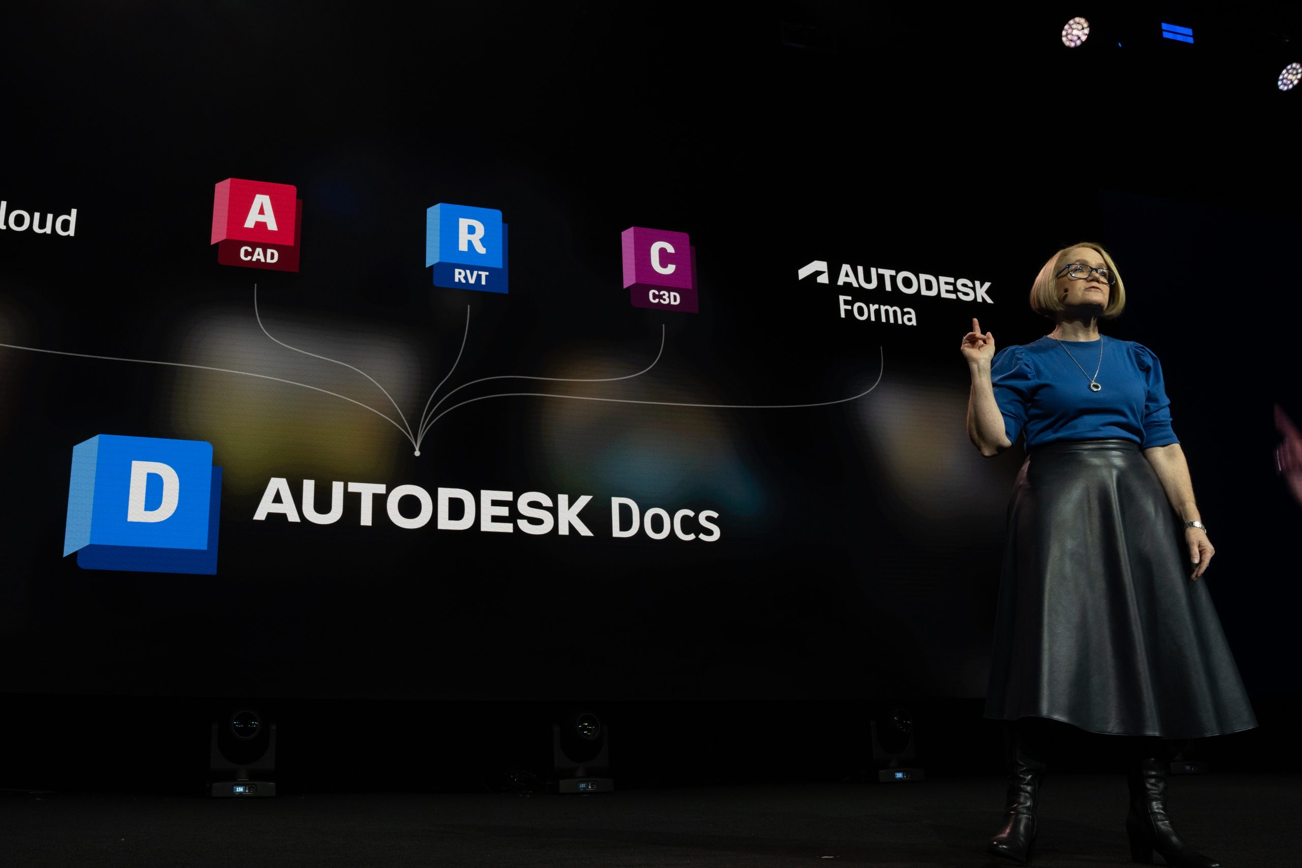Woman on stage giving a presentation about Autodesk Docs