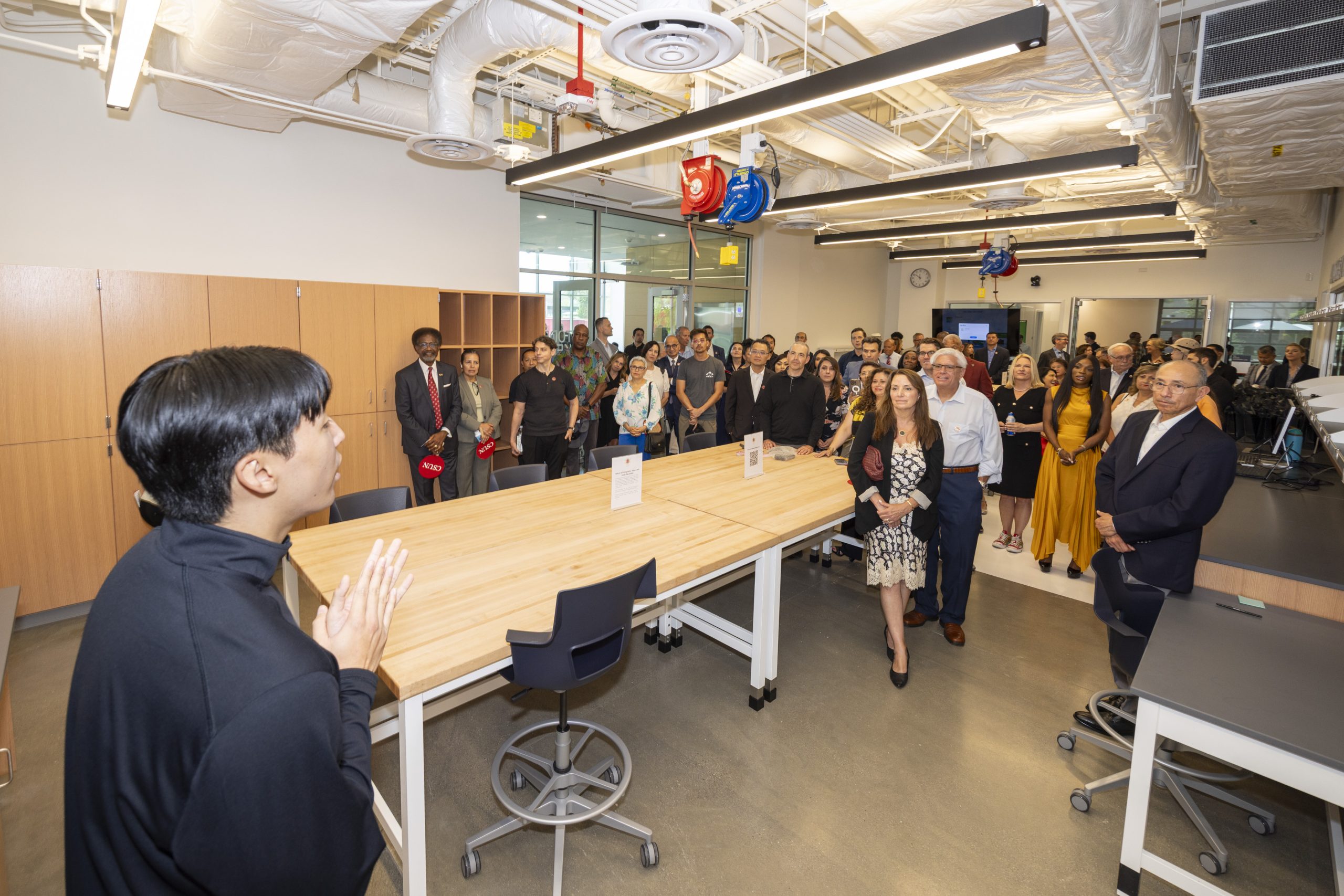 a wide angle of a room full of people paying attention to a speaker