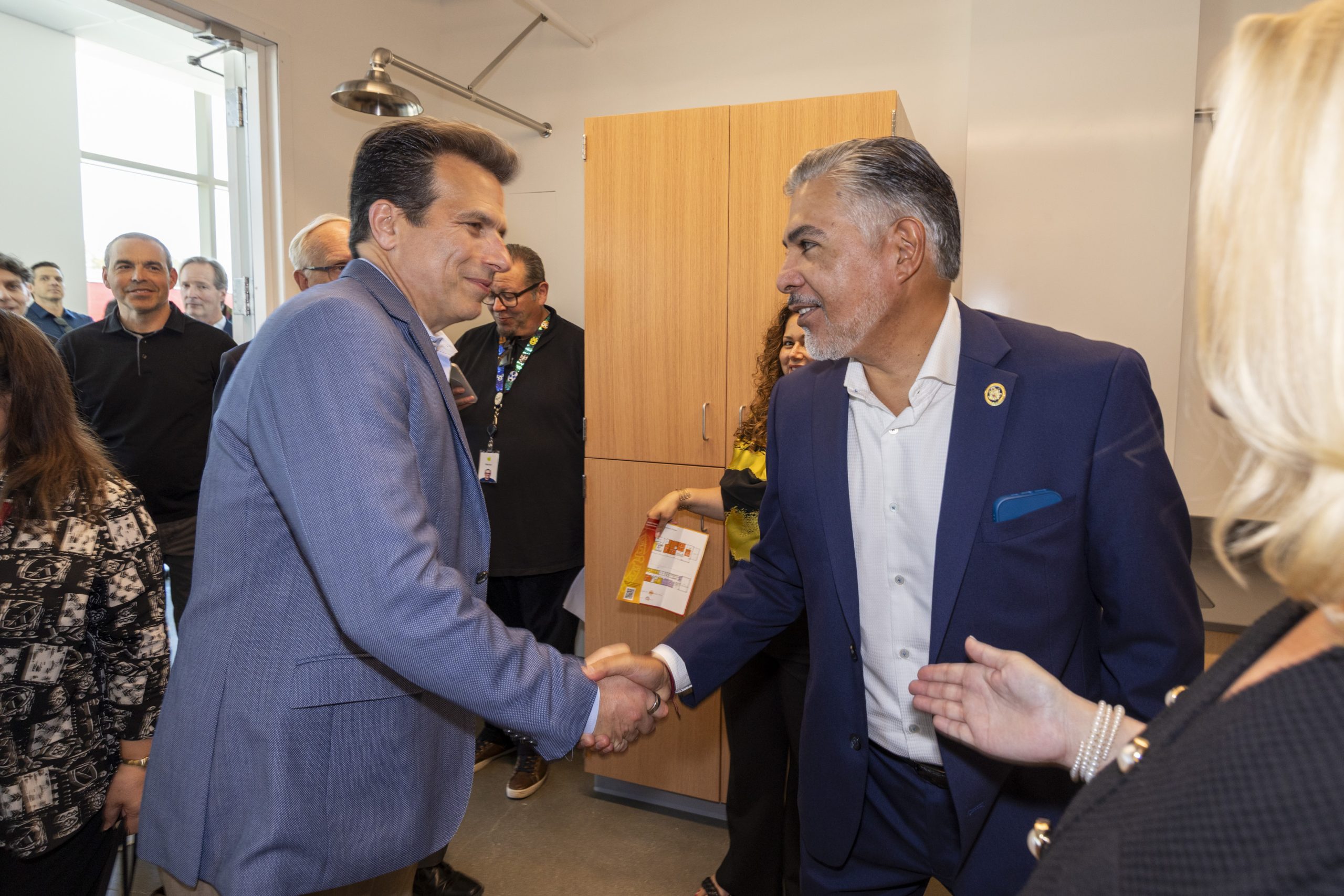 Autodesk CEO Andrew Anagnost shaking hands with another man