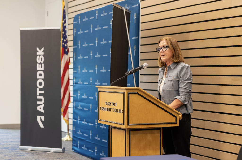 a woman standing at a podium giving a speech