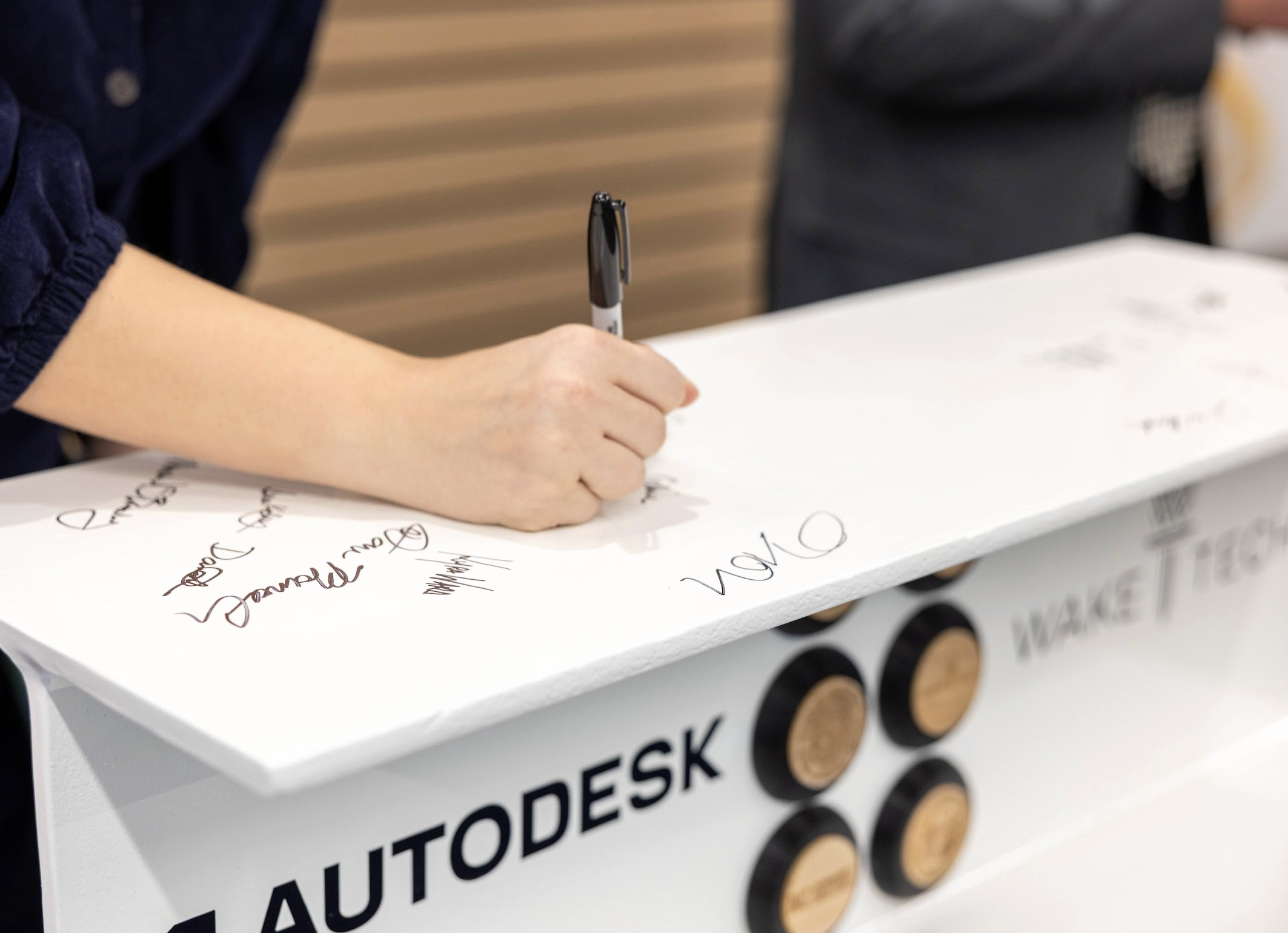 signatures on a white I-beam