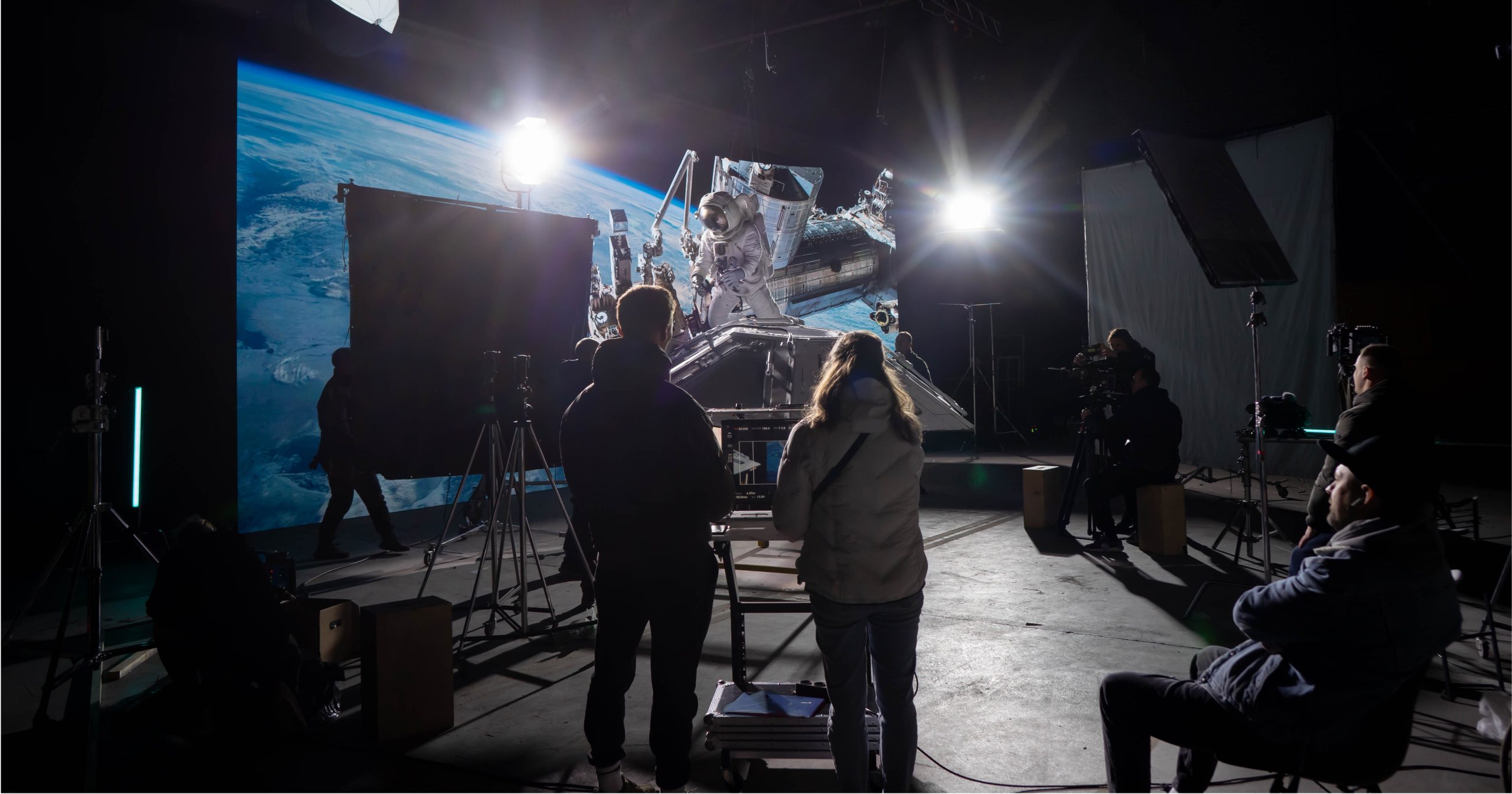 a movie set with production crew watching a scene