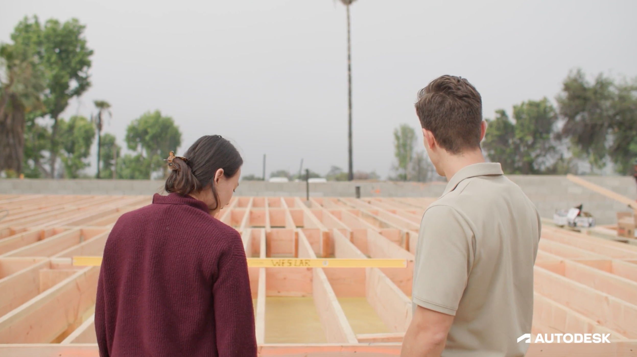 a man and woman looking at a construction site.
