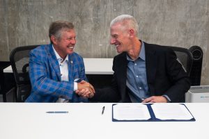 David Brandon, President and CEO of Brandon Construction Company and member of the University of Florida Board of Trustees, sign a new Memorandum of Understanding alongside Autodesk COO Steve Blum.